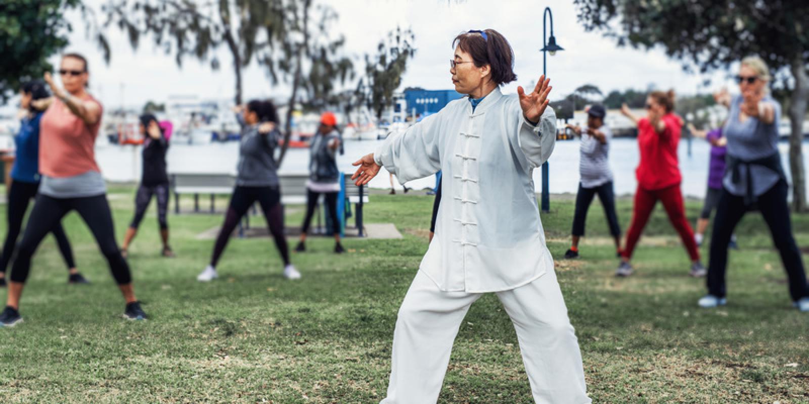 Senior people doing tai chi outdoors