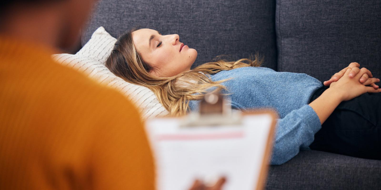 Woman lying on couch in therapy session